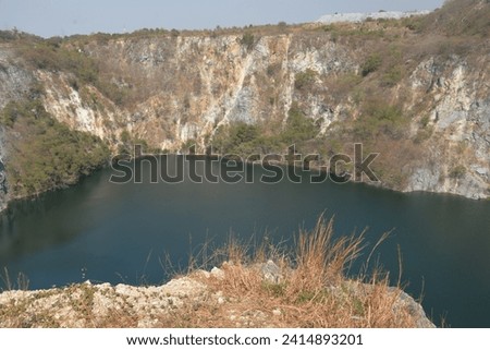 Grand canyon, an old stone and gravel quarry which has stood disused and abandoned for many years, has a picturesque emerald-green lake and cliffs in Chonburi, Thailand, Asia