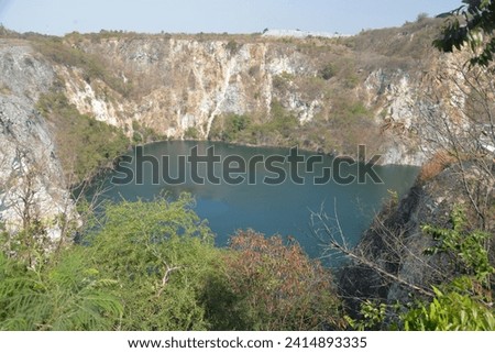 Grand canyon, an old stone and gravel quarry which has stood disused and abandoned for many years, has a picturesque emerald-green lake and cliffs in Chonburi, Thailand, Asia