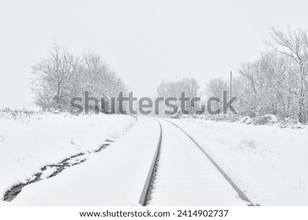 Train tracks in deep snow Royalty-Free Stock Photo #2414902737