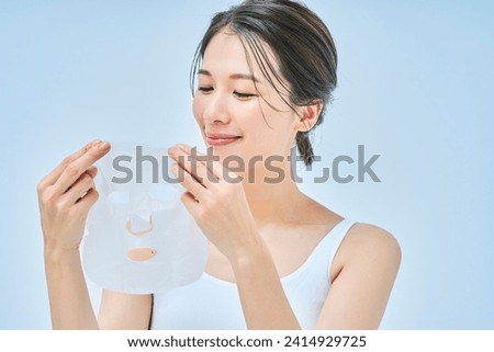 A woman doing skin care using a face pack Royalty-Free Stock Photo #2414929725