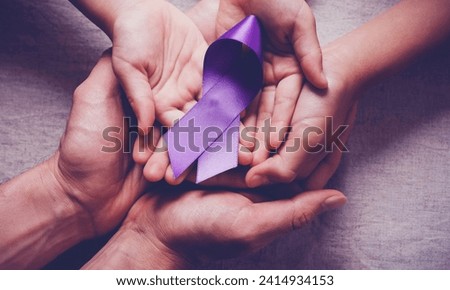 Purple ribbon isolated on white background with cutouts to raise awareness of animal cruelty,Alzheimer's disease, domestic violence, epilepsy, lupus, sarcoidosis, Crohn's disease and pancreatic cancer Royalty-Free Stock Photo #2414934153