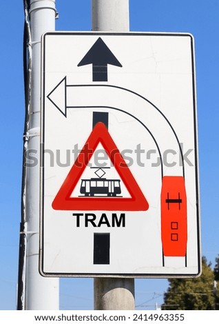 big road sign with attention signs of crossing tram tracks in the city