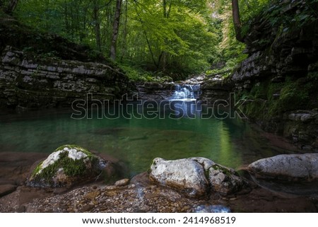 Tranquil water flow deep in the mountain canyon. Nature of Soca valley, Slovenia