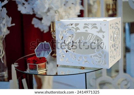 Glass Table With White Box, A Simple, Clean, and Minimalist Display. A glass table showcases a white box in a straightforward and elegant display. Royalty-Free Stock Photo #2414971325