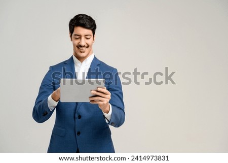 The professional stands with a tablet, his smile and attentive look reflecting an individual adept in digital tools, perfect for representing digital marketing or business innovation, isolated