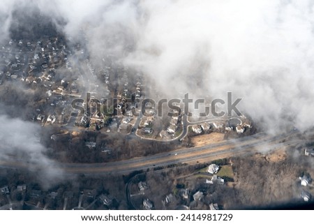 Aerial photograph of suburban areas of Washington DC as seen through clouds