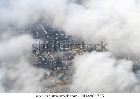 Aerial photograph of suburban areas of Washington DC as seen through clouds