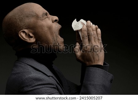 blowing nose after catching the cold and flu with grey background with people stock image stock photo	