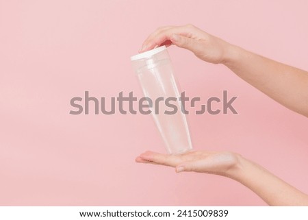 Female hand holds a blank cosmetic container. Cosmetic beauty packaging
