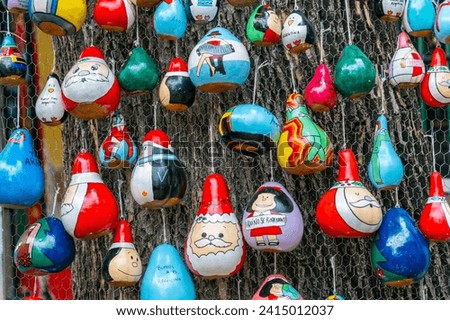 pumpkin christmas ornaments, painted with bright colors, cartoons and argentinean themed. 