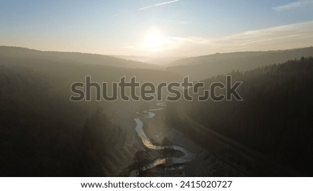 Golden Hour Glow Over Winding River and Forest