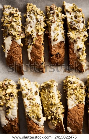 Golden Biscotti or Cantuccini on the baking pan. Traditional Sweet Italian cookies that are making with two times baking, with nuts and dried cranberries. Extra crunchy and dry. Top view Royalty-Free Stock Photo #2415022475