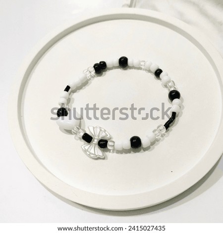 Black and white beaded bracelet. Trendy fashionable accessories design. Isolated in white background. This photo is perfect visual for online shop catalogue, reference idea, or business advertise