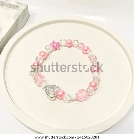 Cute pink beaded bracelet. Trendy fashionable accessories design. Isolated in white background. This photo is perfect visual for online shop catalogue, reference idea, or business advertise. Jewelry