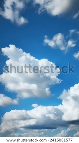 The blue sky radiates natural brightness, adorned with fluffy clouds moving gracefully like a ballet above.