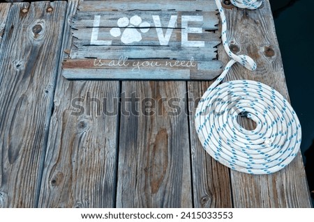 Boat Dock with a Welcome Mat and Coiled Line on a Hardwood Planked Dock.
