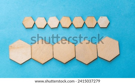 image of different types of wooden hexagons with different sizes arranged horizontally on a blue background 
