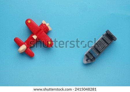 Flatlay picture of airplane and vessel miniature. Delivery shipment concept