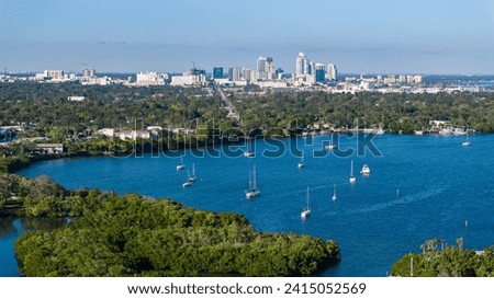 Sailboats and Catamarans floating in Big Bayou inlet off the coast of St. Petersburg, Florida with Downtown St. Pete in the Distance Royalty-Free Stock Photo #2415052569