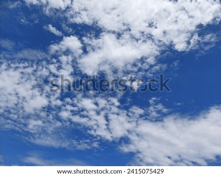white cloud under sunny blue sky shot in the middle of the day