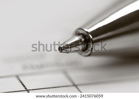 Close up view  ball point pen on a tax document, focus stacked image.