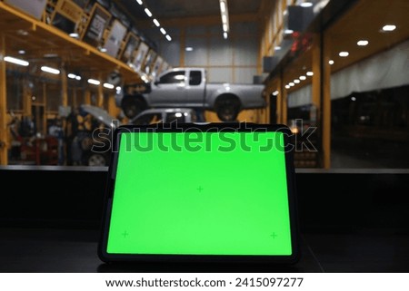  Green screen on laptop against Car Garage, green screen workspace with Car maintenance service on background