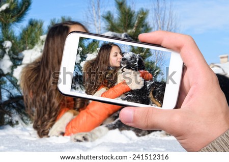 Girl with a dog in the snow.
