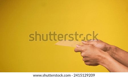 Man's hand gives money envelope isolated on pink background