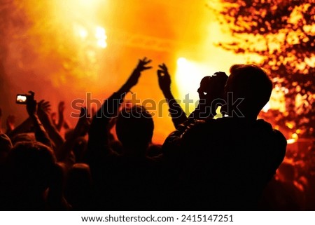 People, silhouette and camera with crowd at festival, music or concert for pictures, social media or news article. Dark, photographer or person with bright, orange and lighting for rock performance