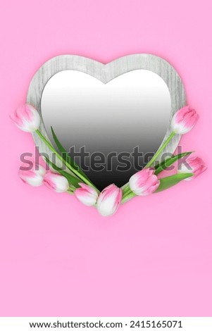Beautiful tulip flower heart shaped frame with gradient insert on pink background. Minimal floral Spring, Mothers Day, Anniversary and Easter nature design.