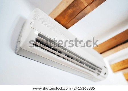 Air conditioner inverter mounted on the wall. Royalty-Free Stock Photo #2415168885