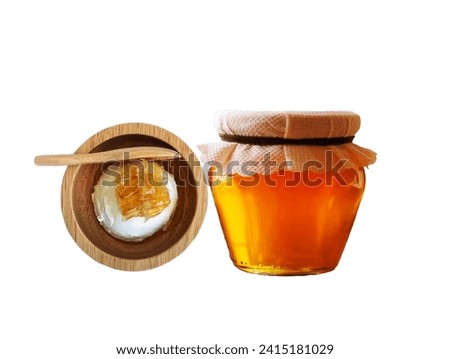 The white background in the picture is a brown wooden cup with white ice cream and a golden-yellow honey cube. A brown wooden spoon is placed in the cup nearby. There is a jar of honey tied to the mou