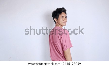 Handsome Asian man with a thin smile poses coolly on a white background Royalty-Free Stock Photo #2415193069