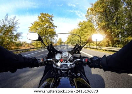 Riding a motorcycle on a homely and sunny day