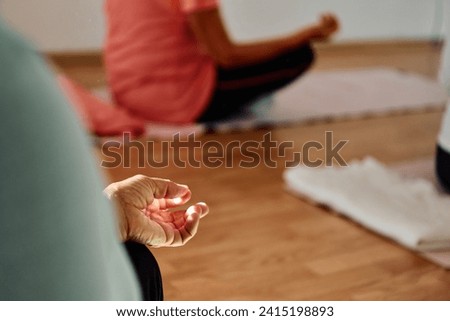 In this sunlit space, a senior woman's hand gracefully engages in various yoga poses, embodying the essence of active aging, health, and inner peace Royalty-Free Stock Photo #2415198893