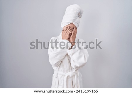 Blonde caucasian woman wearing bathrobe rubbing eyes for fatigue and headache, sleepy and tired expression. vision problem 