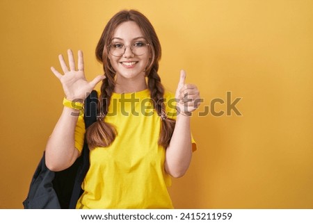 Young caucasian woman wearing student backpack over yellow background showing and pointing up with fingers number six while smiling confident and happy. 