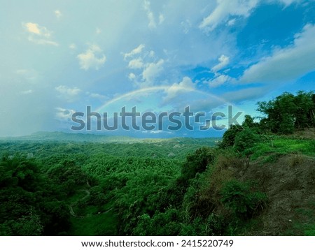 Wonderland-like mountains and forests, with beautiful rainbows appearing after the rain. picture of heaven