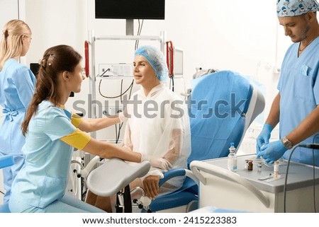 Hospital staff preparing pregnant patient to examination before childbirth