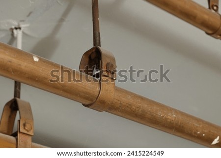 Pipes Secured to the Ceiling with Metal Brackets Royalty-Free Stock Photo #2415224549