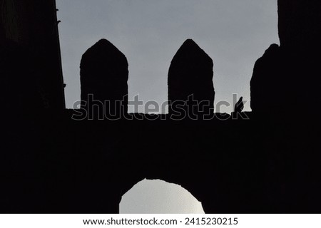 Evocative silhouette of an ancient stone wall, standing as a testament to time, casting a nostalgic and enduring presence Royalty-Free Stock Photo #2415230215
