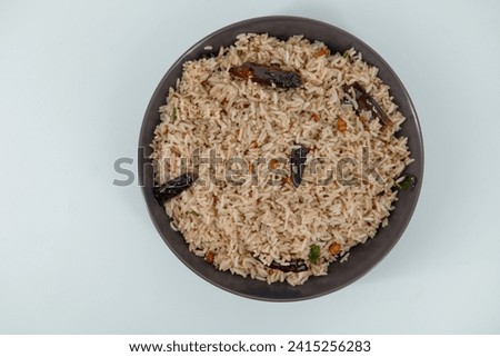 Tamarind Rice  Puliyodharai  Puliyogare - Tangy and spicy South Indian rice dish as break fast , Lunch or dinner. Tamarind as main ingredient and other spices. Famous Tamilnadu dish. Royalty-Free Stock Photo #2415256283