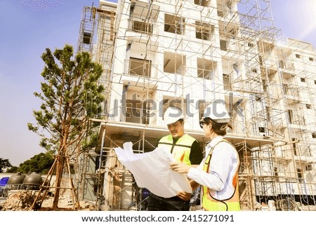 Male and female architects caucasian oversee construction new condominium civil engineers inspect blueprints advise planning residential projects real estate luxury and environmentally friendly. Royalty-Free Stock Photo #2415271091