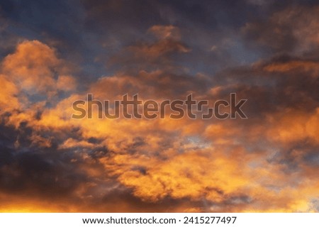 Bright yellow clouds at sunset in sky close up