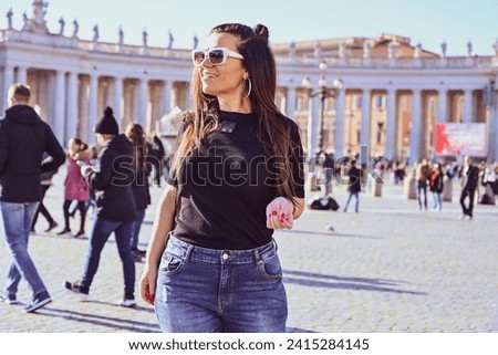 Rome,Italy, Vatican City, Rome, Saint Peter's Basilica in St. Peter's Square  Young beautiful woman  using a mobile phone taking a pictures.Concept of Italian gastronomy and travel