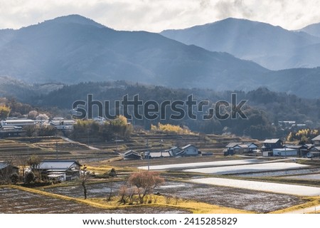 Beautiful view of local houses and rice farm in valley surrounding by mountain with rays light near Magome juku, Kiso valley, Nakatsugawa, Gifu Prefecture, Japan