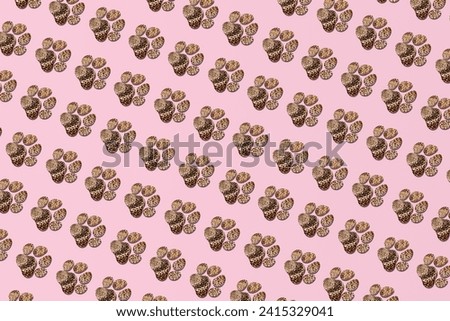 Paw prints, leopard print on pastel pink background.