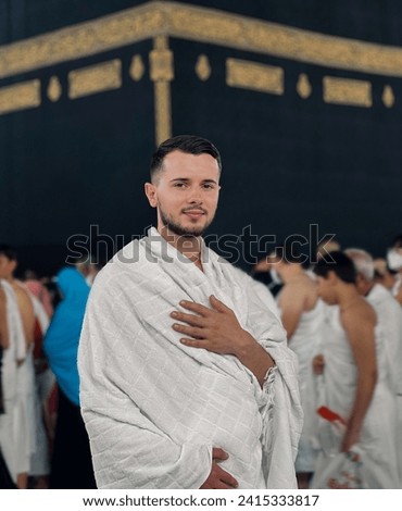 Muslim Arabic man praying at Kaaba in Mecca performs the Hajj the holy Islamic pray. Royalty-Free Stock Photo #2415333817