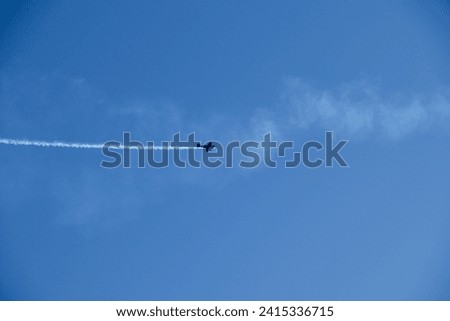 A photo of a sport plane soaring through the sky