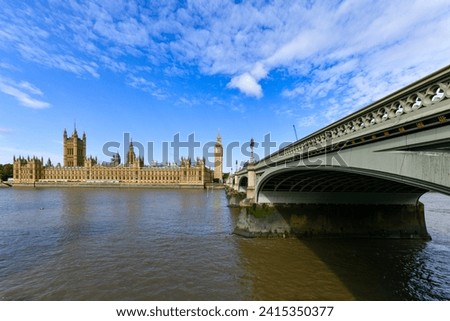 Big Ben and Parliament across the Thames River and Westminster Bridge in London, UK.